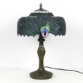 Tiffany Peacock Feather Stained Glass Table Lamp lifestyle photo styled in modern interior - Neovall designer lighting