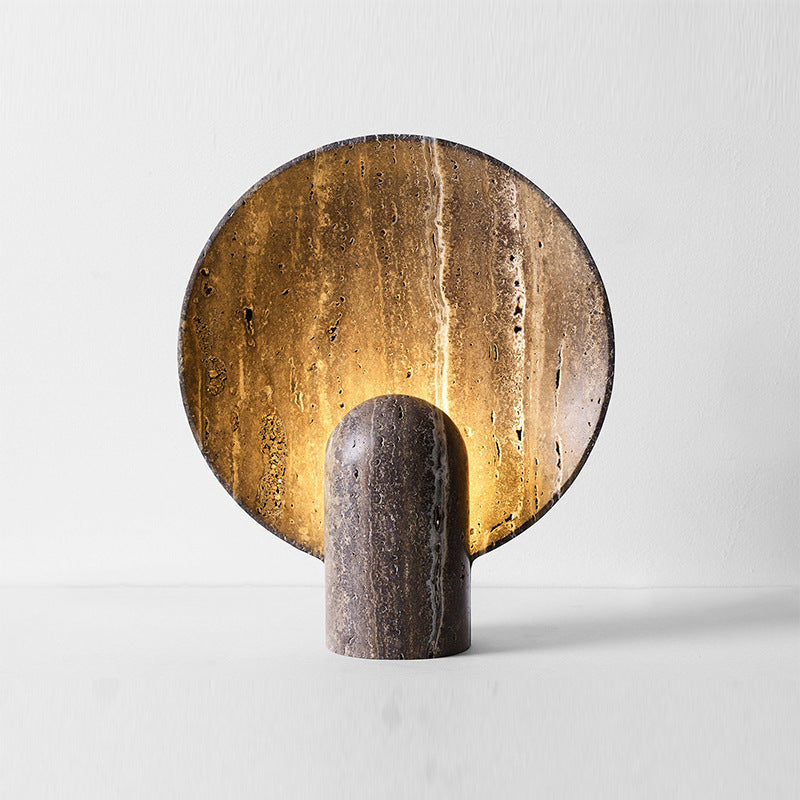 Travertine disc lamp on console table - warm halo glow against wall