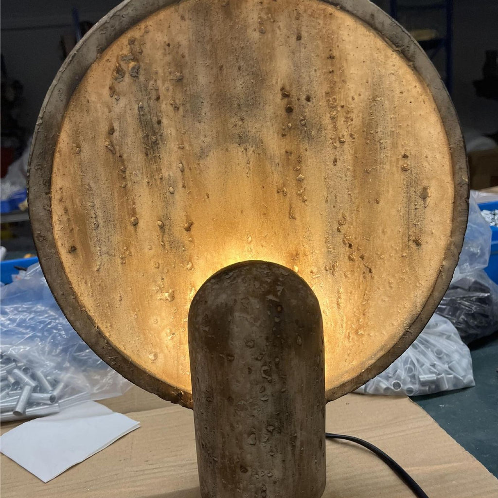 Travertine disc lamp in living room setting - sculptural organic modern design