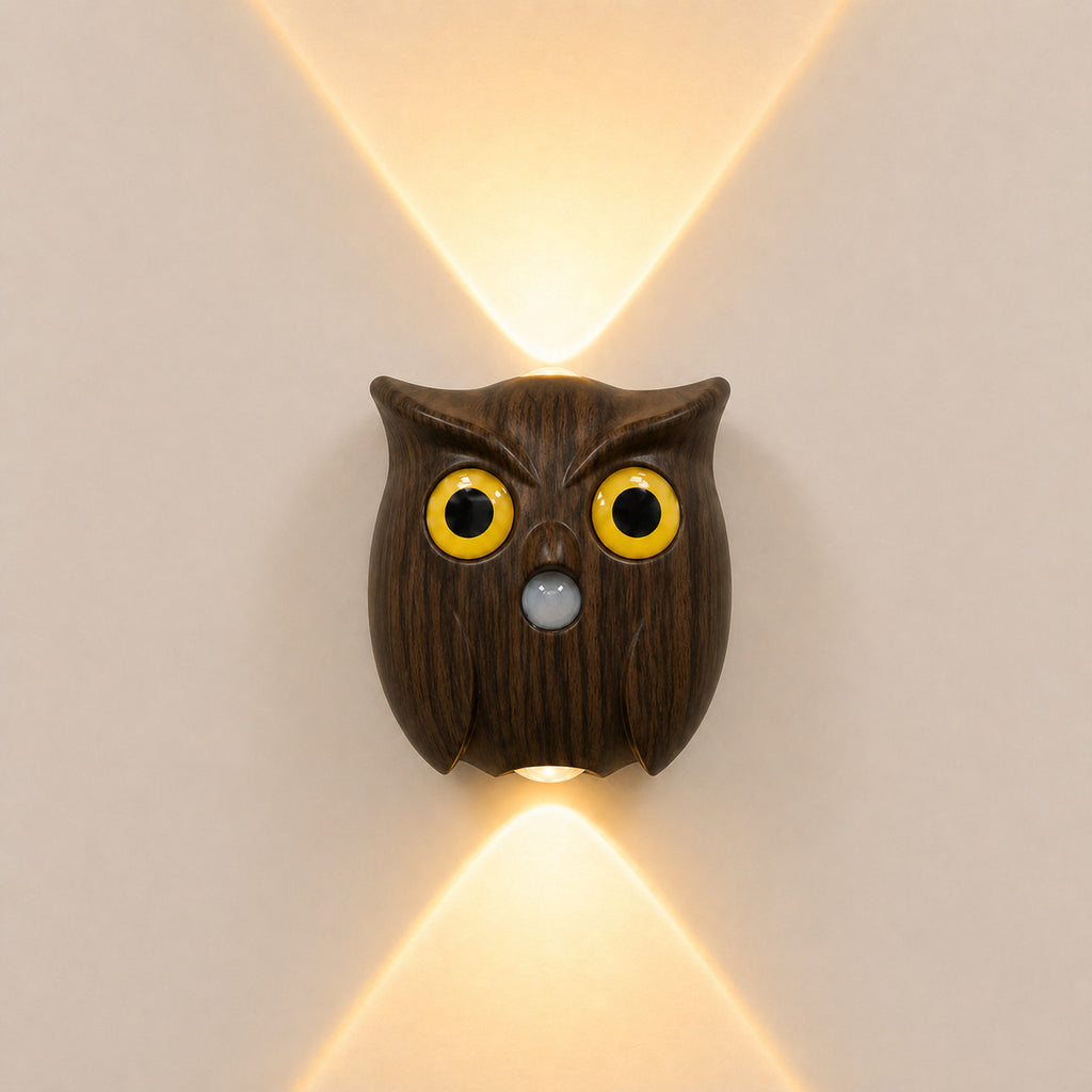 Nordic owl motion-sensor wall light in dark wood finish glowing warm on a wall