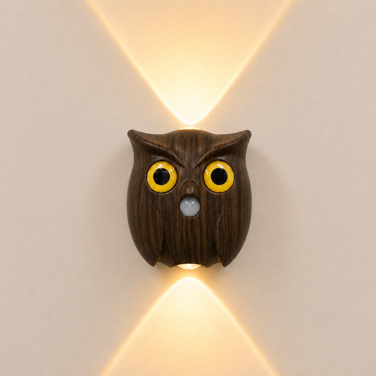 Nordic owl motion-sensor wall light in dark wood finish glowing warm on a wall
