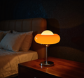 Bauhaus Amber Glass Table Lamp glowing warm on bedside table - Neovall